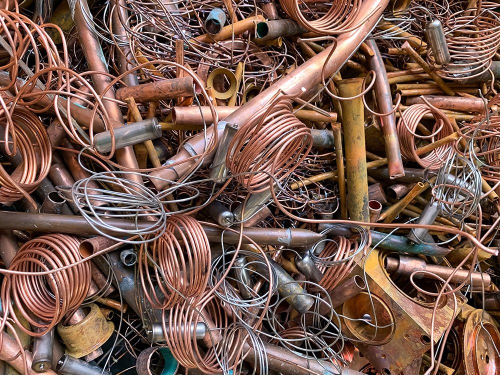 Copper scrap tubes and wire ready to be recycled, portrait view